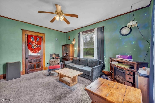 living room with a ceiling fan, ornamental molding, and carpet floors