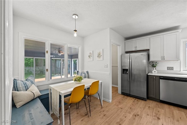 149 Sand Run Rd, Akron, OH 44313 - kitchen featuring appliances with stainless steel finishes, plenty of natural light, light countertops, light wood-style flooring, and a textured ceiling