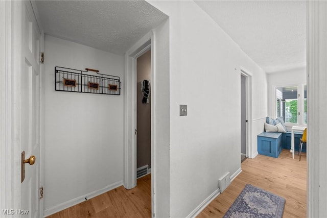 149 Sand Run Rd, Akron, OH 44313 - hall featuring light wood-style flooring, a textured ceiling, and baseboards