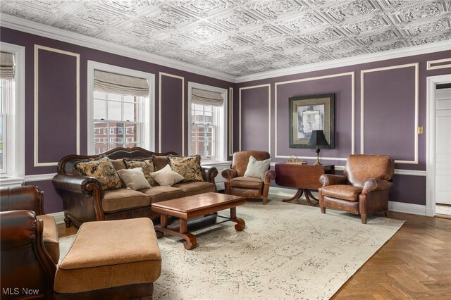 living room featuring baseboards and an ornate ceiling