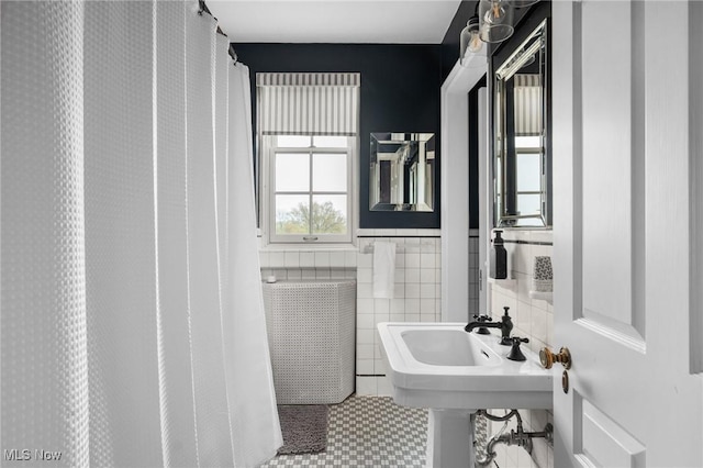 full bath featuring radiator, tile walls, and tile patterned flooring