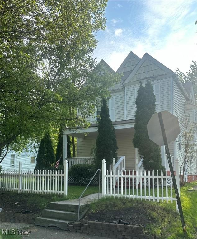 913 Shorb Ave NW, Canton, OH 44703 - victorian house with a porch and a fenced front yard