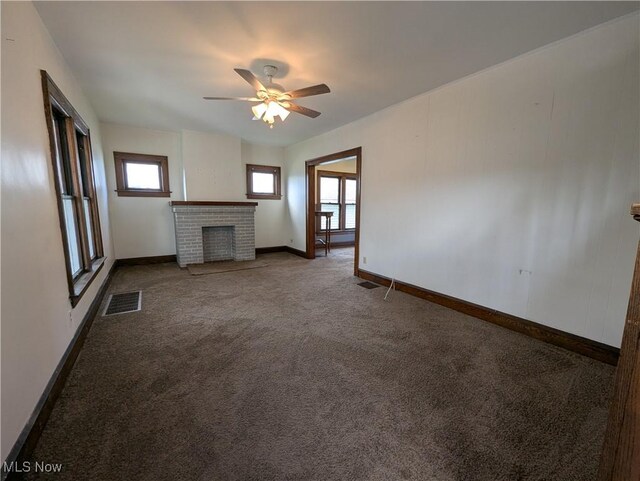 unfurnished living room with a fireplace, carpet, baseboards, and a ceiling fan