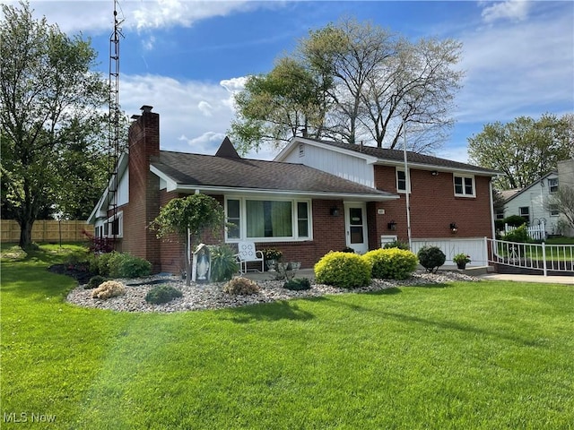 681 Grandview Ave, East Palestine, OH 44413 - rear view of house featuring a chimney, brick siding, an attached garage, and roof with shingles