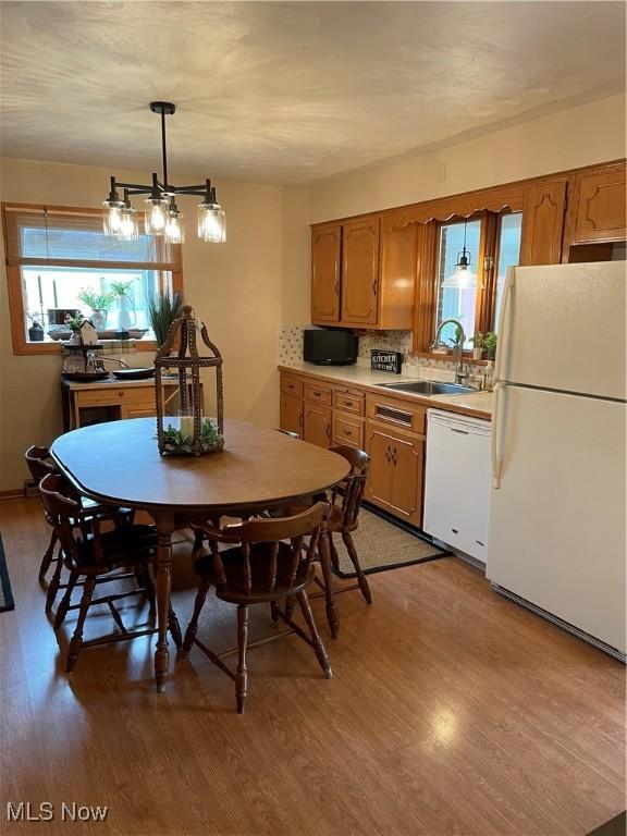 681 Grandview Ave, East Palestine, OH 44413 - kitchen featuring white appliances, light wood-style flooring, a sink, brown cabinets, and light countertops