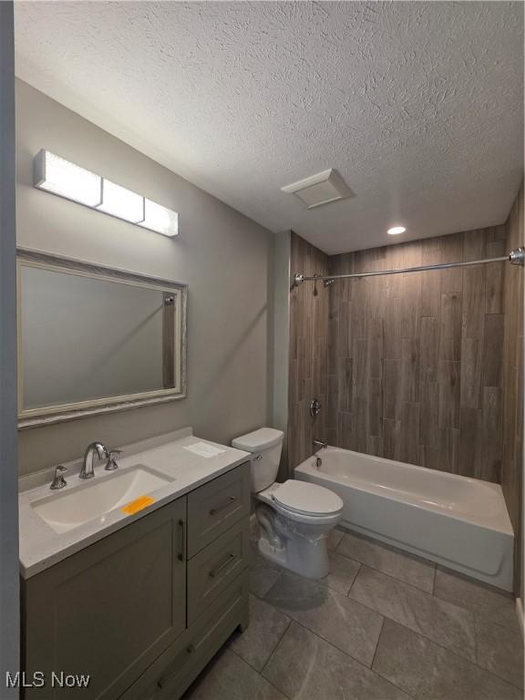 990 E Blvd, Aurora, OH 44202 - full bath featuring vanity, toilet, shower / bathtub combination, a textured ceiling, and tile patterned floors