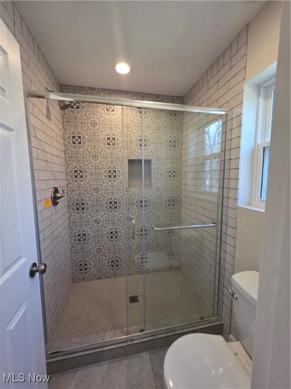 990 E Blvd, Aurora, OH 44202 - full bathroom featuring toilet, tile patterned flooring, and a shower stall