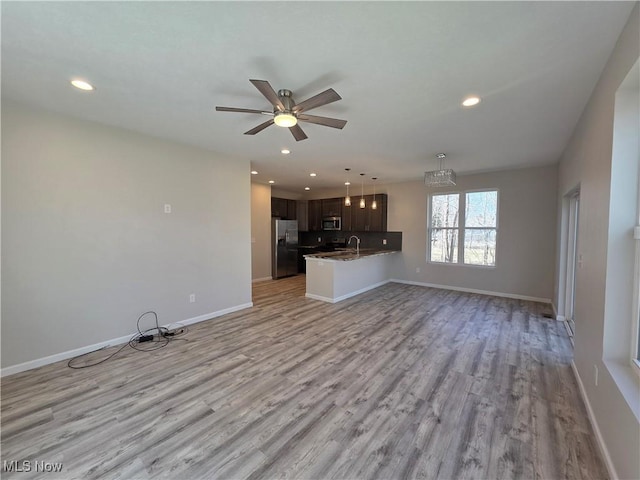 990 E Blvd, Aurora, OH 44202 - unfurnished living room with recessed lighting, light wood finished floors, baseboards, a sink, and ceiling fan