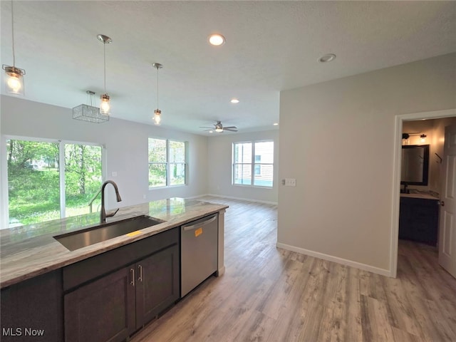 990 E Blvd, Aurora, OH 44202 - kitchen with stainless steel dishwasher, a sink, light wood-type flooring, baseboards, and pendant lighting