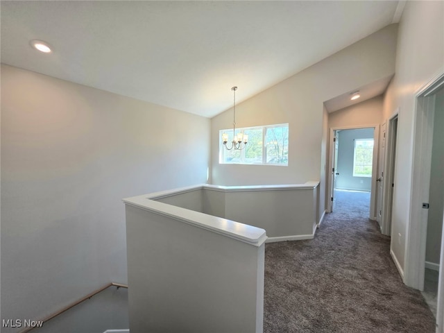 990 E Blvd, Aurora, OH 44202 - hallway featuring lofted ceiling, a chandelier, dark carpet, baseboards, and an upstairs landing