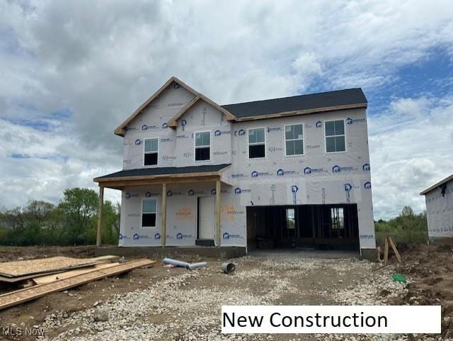 2986 Mcintosh Dr NE, Louisville, OH 44641 - property under construction featuring covered porch and a garage