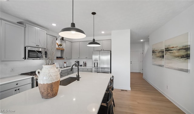 2986 Mcintosh Dr NE, Louisville, OH 44641 - kitchen featuring stainless steel appliances, gray cabinetry, a sink, recessed lighting, and backsplash