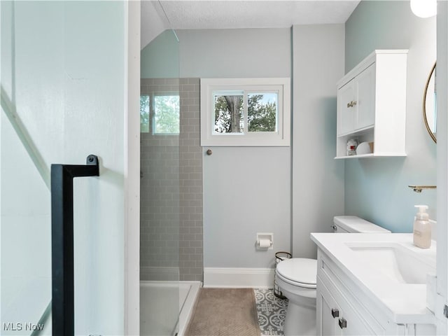 full bathroom featuring toilet, a stall shower, tile patterned flooring, vanity, and baseboards