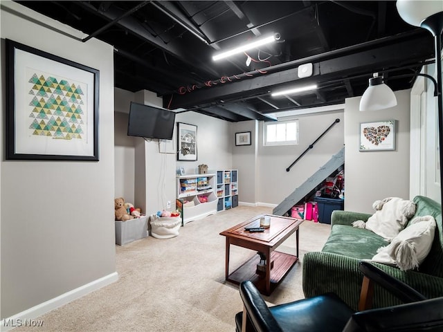 carpeted living area featuring baseboards and stairway