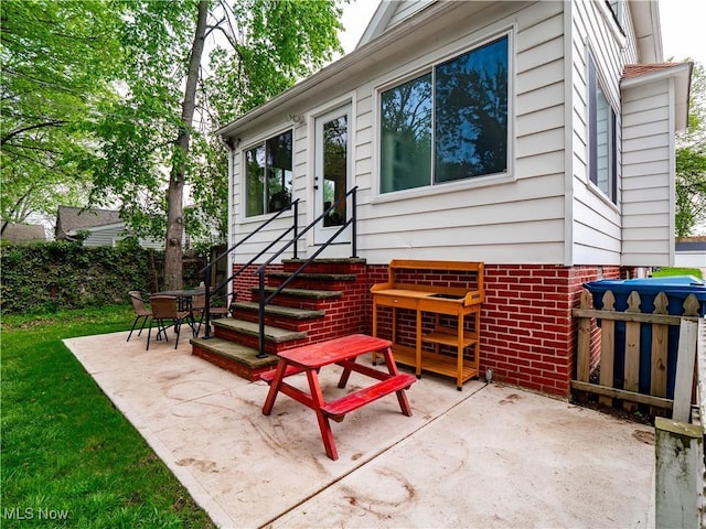 doorway to property featuring a patio and fence
