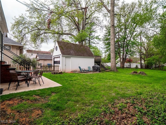 view of yard with stairway, an outdoor structure, and a patio area