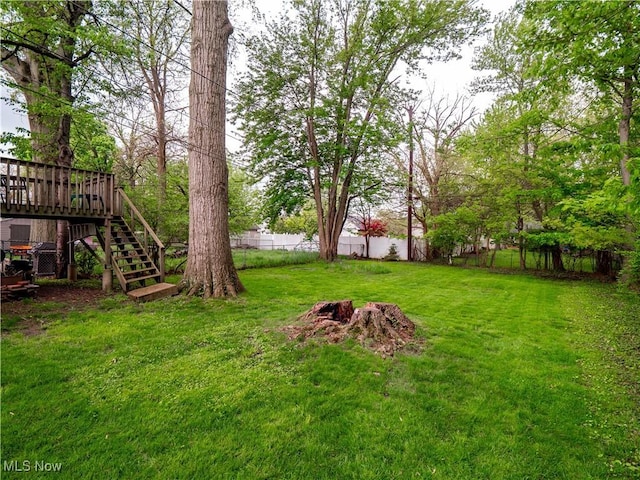 view of yard featuring stairs and a wooden deck