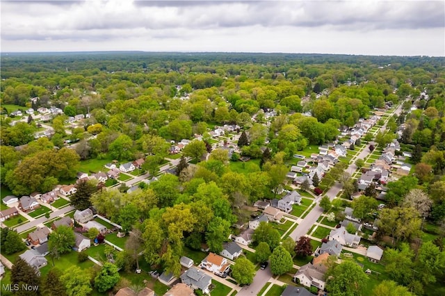 aerial view of residential area with a heavily wooded area