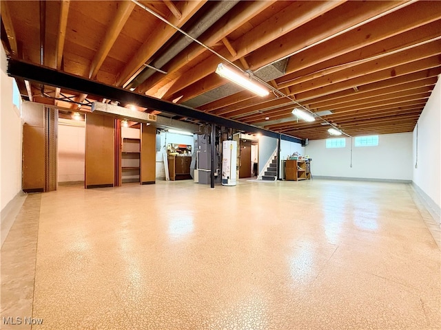 below grade area featuring water heater, stairway, and heating unit