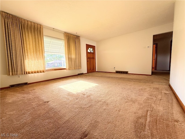 empty room with carpet floors and baseboards
