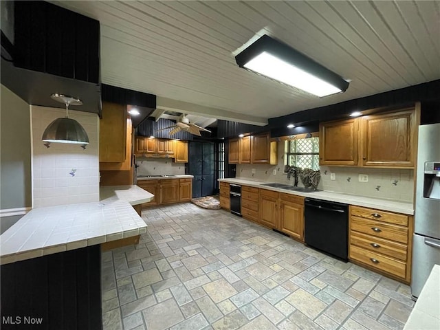 1585 County Road 9, Marietta, OH 45750 - kitchen with black dishwasher, a sink, a ceiling fan, and brown cabinetry