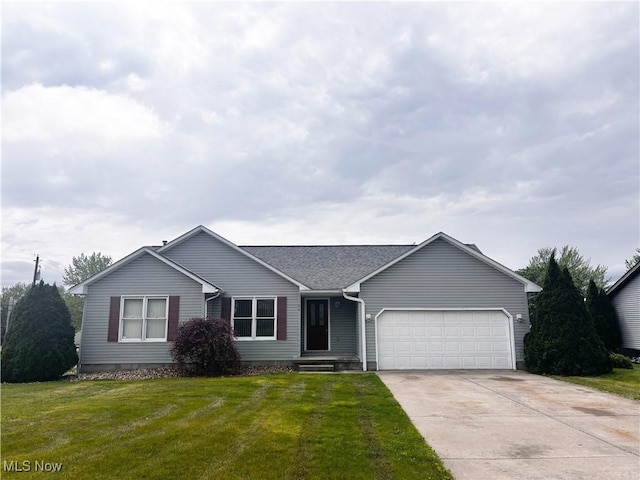 ranch-style home featuring a garage, concrete driveway, and a front yard