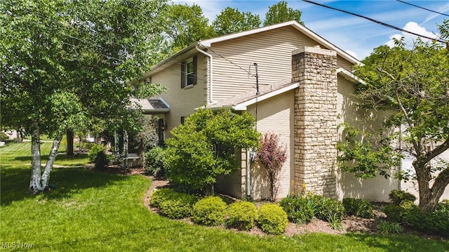 5500 12th Ave, Vienna, WV 26105 - view of side of property with a yard and brick siding