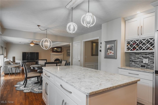 5500 12th Ave, Vienna, WV 26105 - kitchen featuring a chandelier, ceiling fan, a center island, tasteful backsplash, and open floor plan