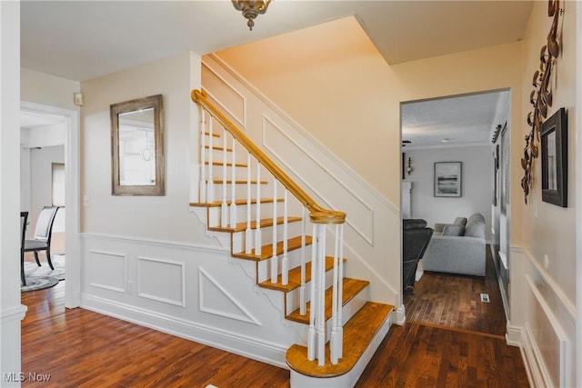 5500 12th Ave, Vienna, WV 26105 - stairway with wood finished floors, wainscoting, and a decorative wall
