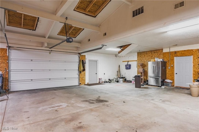 5500 12th Ave, Vienna, WV 26105 - garage featuring freestanding refrigerator and a garage door opener