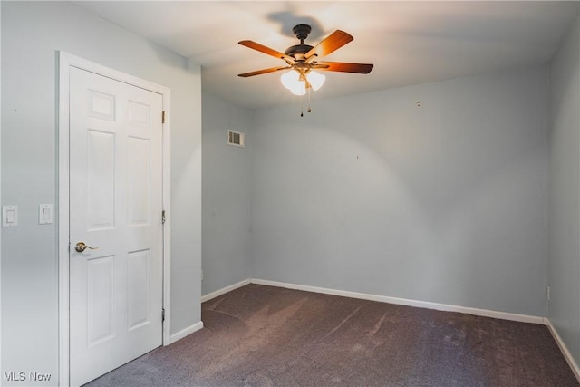 5500 12th Ave, Vienna, WV 26105 - spare room featuring dark carpet, a ceiling fan, and baseboards