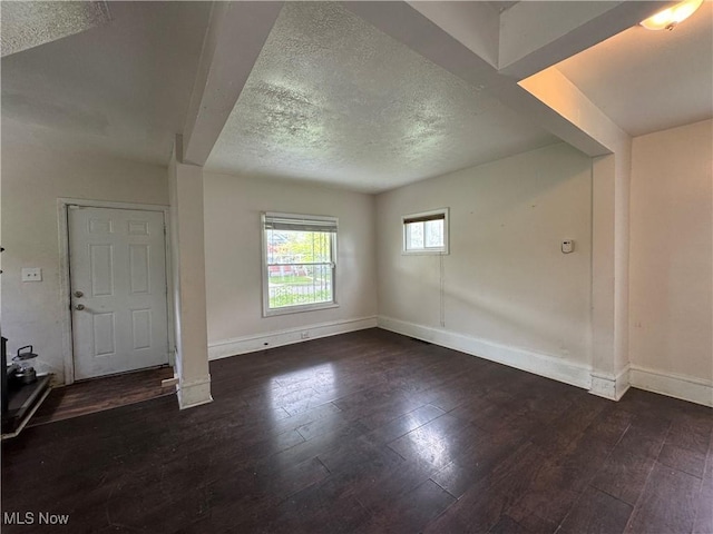 12423 Phillips Ave, Cleveland, OH 44108 - unfurnished living room featuring a textured ceiling, hardwood / wood-style floors, and baseboards