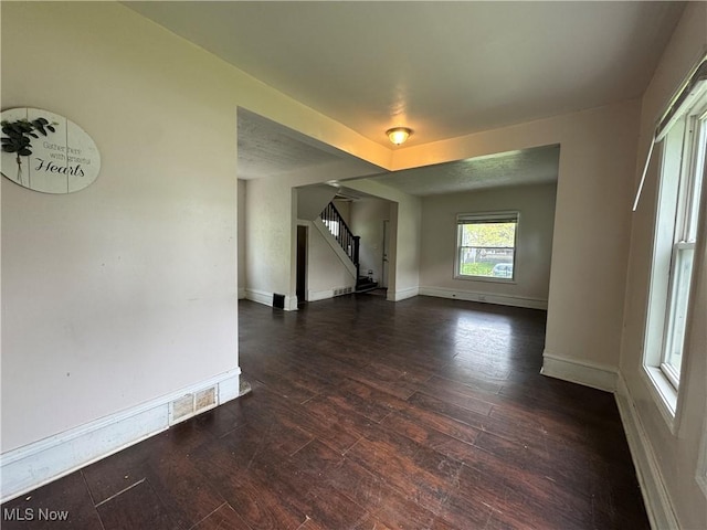 12423 Phillips Ave, Cleveland, OH 44108 - unfurnished living room with stairway, wood finished floors, and baseboards