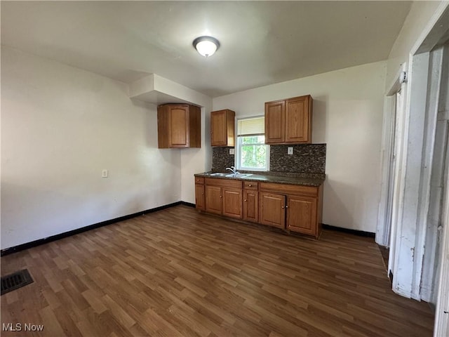 12423 Phillips Ave, Cleveland, OH 44108 - kitchen featuring dark countertops, dark wood finished floors, baseboards, and brown cabinets