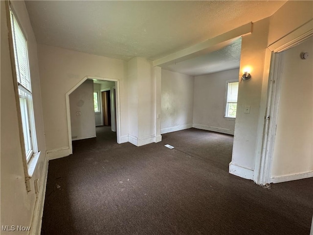 12423 Phillips Ave, Cleveland, OH 44108 - unfurnished room with dark colored carpet, baseboards, and a textured ceiling