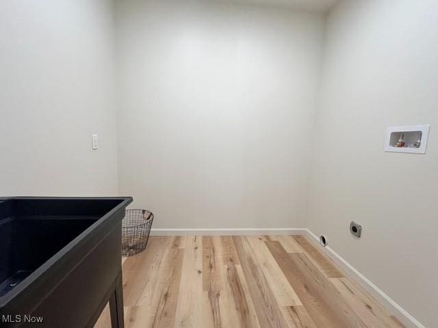 713 N Broadway St, New Philadelphia, OH 44663 - clothes washing area with light wood-style flooring, hookup for a washing machine, baseboards, and hookup for an electric dryer