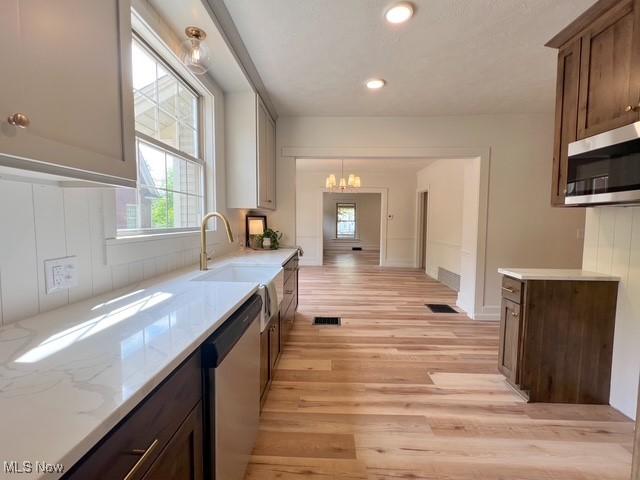 713 N Broadway St, New Philadelphia, OH 44663 - kitchen with appliances with stainless steel finishes, a chandelier, light wood-style floors, recessed lighting, and a sink