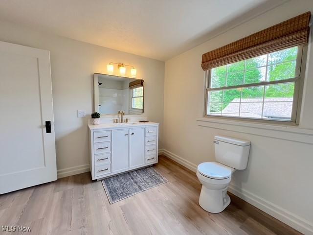 713 N Broadway St, New Philadelphia, OH 44663 - full bath with wood finished floors, toilet, and vanity