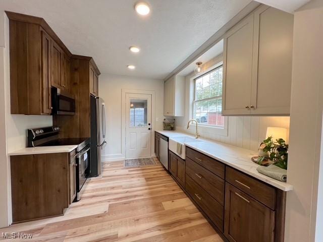 713 N Broadway St, New Philadelphia, OH 44663 - kitchen with appliances with stainless steel finishes, light wood-style flooring, light countertops, and recessed lighting