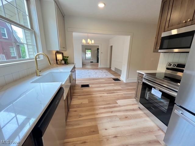 713 N Broadway St, New Philadelphia, OH 44663 - kitchen with stainless steel appliances, a chandelier, plenty of natural light, light wood finished floors, and recessed lighting