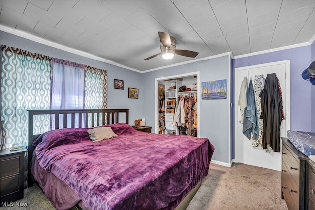 bedroom featuring carpet floors, ornamental molding, a ceiling fan, and a closet