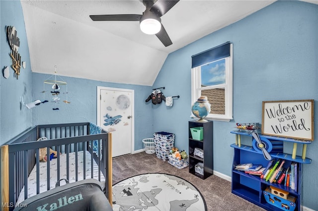 bedroom with lofted ceiling, carpet, a nursery area, ceiling fan, and baseboards