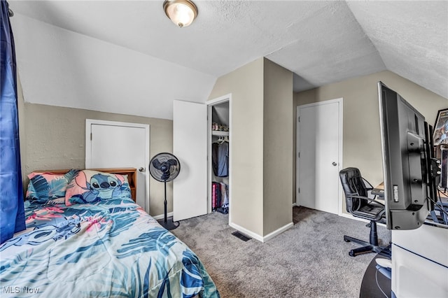 carpeted bedroom featuring lofted ceiling, a textured ceiling, an office area, and baseboards
