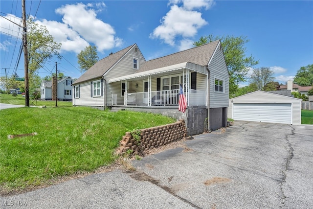 view of front of house featuring covered porch, a garage, an outdoor structure, a front lawn, and a shingled roof