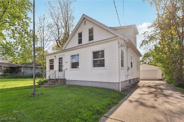 1540 Grand Park Ave, Akron, OH 44310 - view of front of house with an outbuilding, a garage, and a front lawn