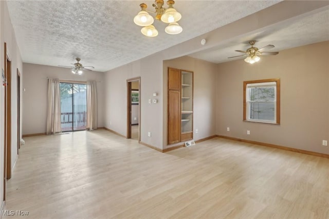 1540 Grand Park Ave, Akron, OH 44310 - empty room with ceiling fan, light wood-style flooring, a textured ceiling, and baseboards