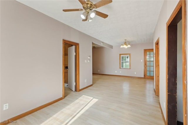 1540 Grand Park Ave, Akron, OH 44310 - spare room with a chandelier, light wood-style floors, baseboards, and a ceiling fan