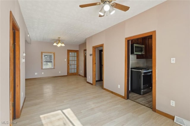 1540 Grand Park Ave, Akron, OH 44310 - spare room featuring light wood-type flooring, a chandelier, and baseboards