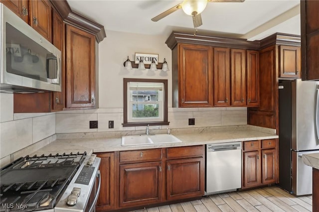 1540 Grand Park Ave, Akron, OH 44310 - kitchen featuring appliances with stainless steel finishes, a sink, decorative backsplash, and ceiling fan