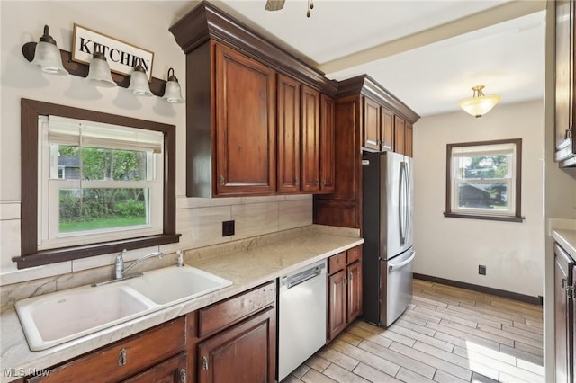 1540 Grand Park Ave, Akron, OH 44310 - kitchen with freestanding refrigerator, dishwasher, plenty of natural light, and a sink
